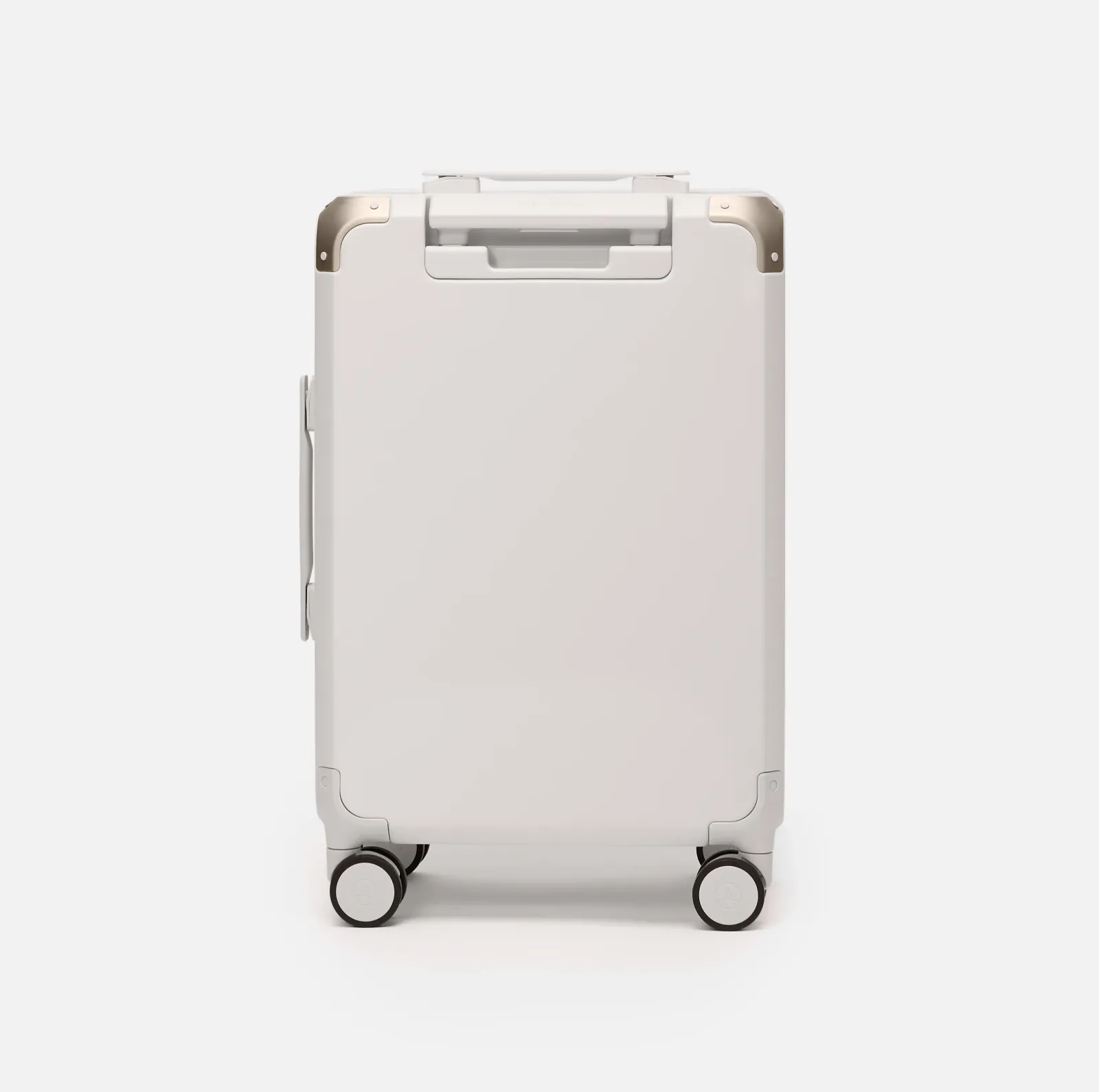 Beige hard shell carry-on suitcase, The Cabin Trunk Essential by Armoir, rear angle view