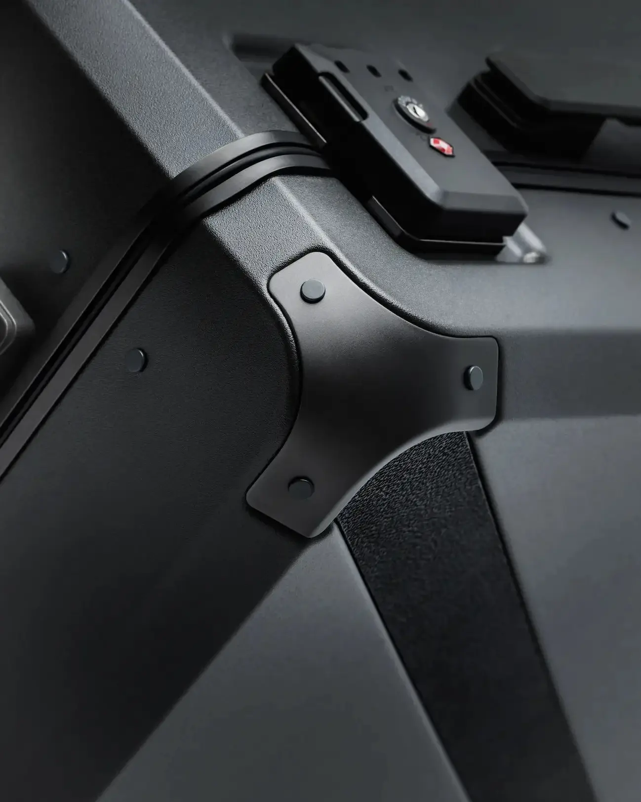 Detail of Armoir carry-on trunk showing reinforced aluminum corner and TSA-approved lock